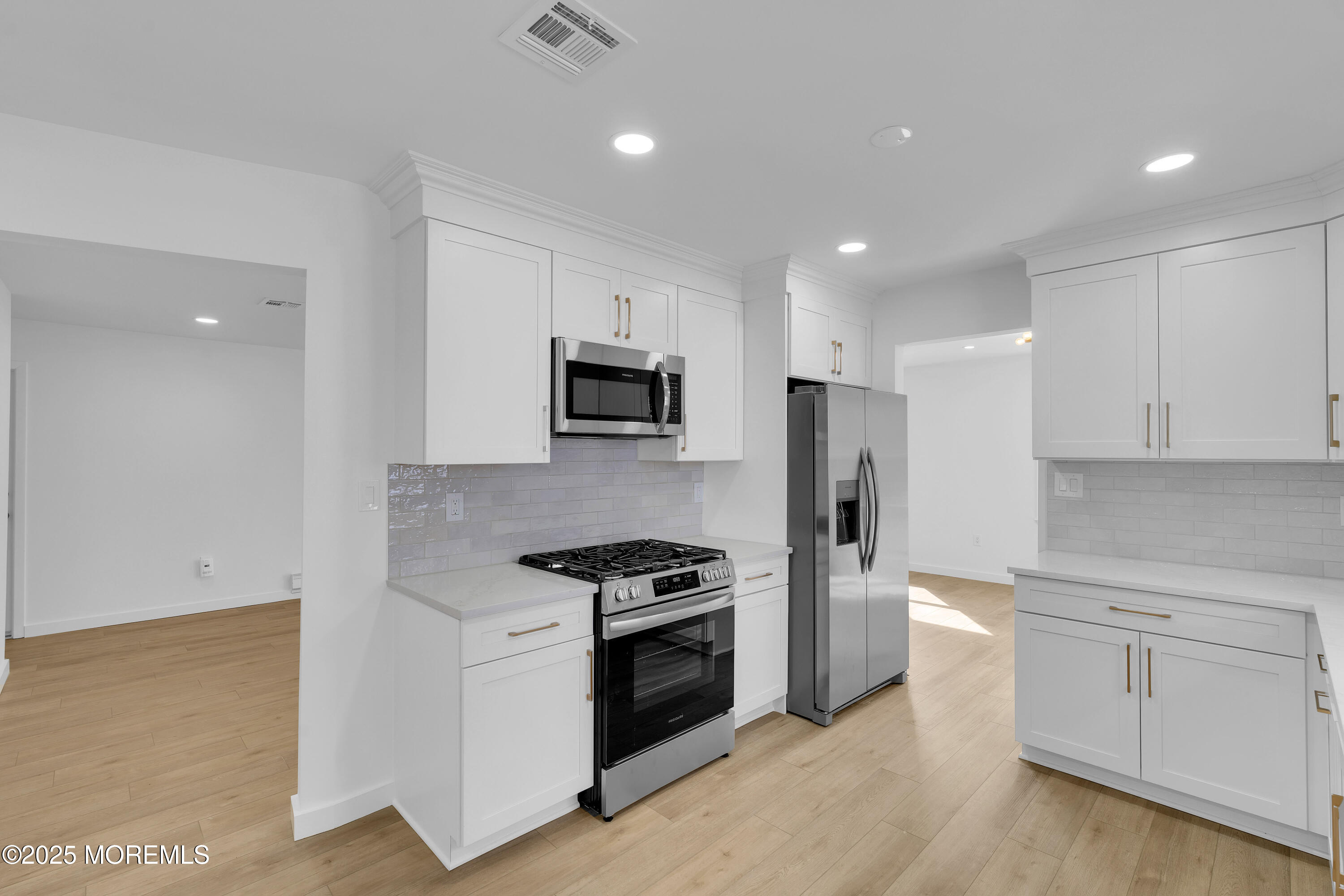 3 Tudor Court Brick, NJ 08723 - Photo 10 of 36 a kitchen with white cabinets and stainless steel appliances