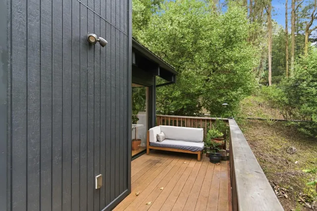 a balcony with furniture and wooden floor