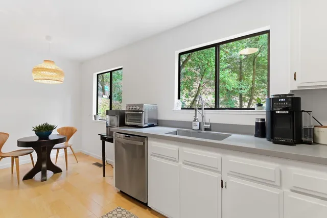 a kitchen with a sink cabinets and window