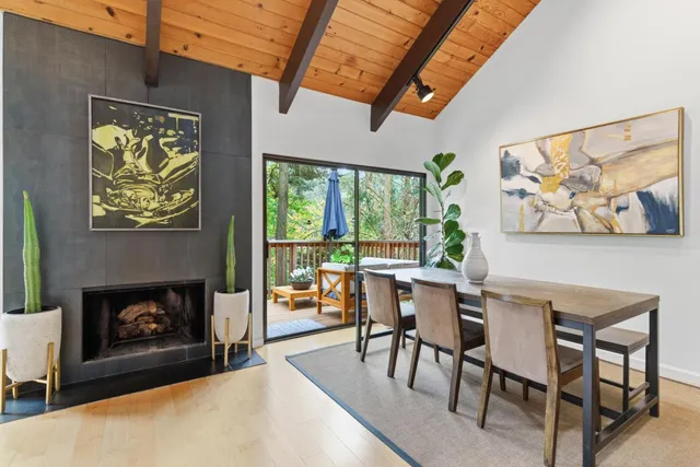 a dining room with furniture a floor to ceiling window and a fireplace