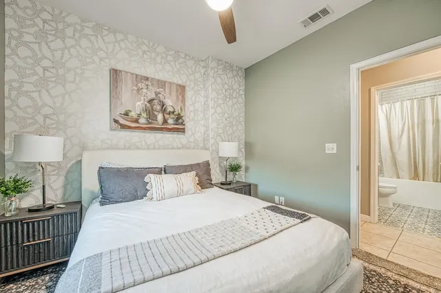 a bedroom with a bed and a painting on the wall