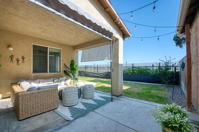 a living room with patio furniture and garden