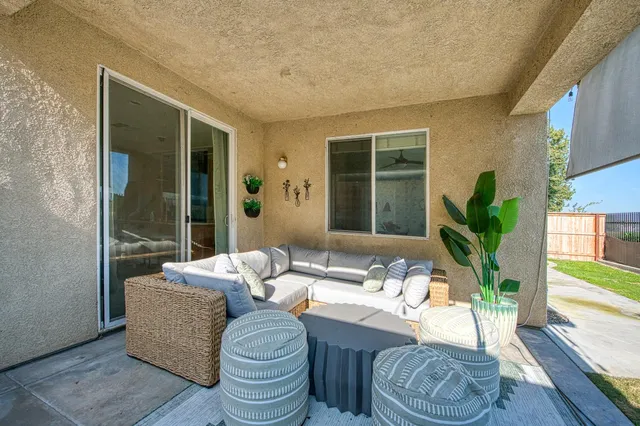 a living room with furniture and a potted plant