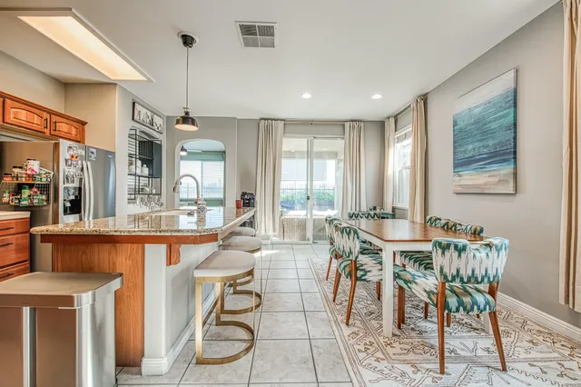 a view of a dining room with furniture and a large window