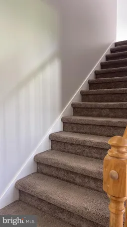 a view of an empty room with closet and a window