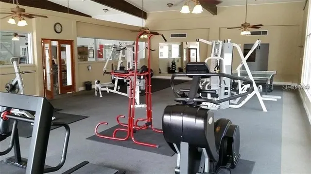 a room with gym equipment and large mirror