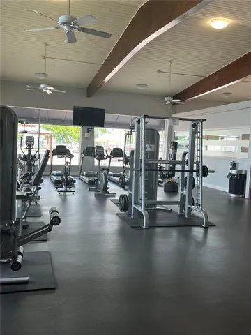 a room with furniture pool table and wooden floor