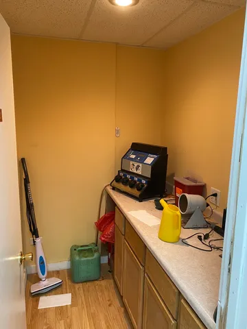 a view of kitchen with a sink stove and wooden floor