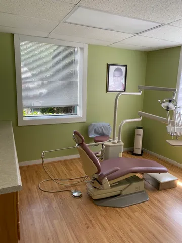 a room with pool table and windows