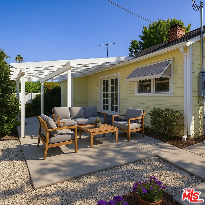 7465 North Forbes Ave Lake Lake Balboa, CA 91406 - Photo 12 of 13 a view of a patio with table and chairs potted plants and floor to ceiling window