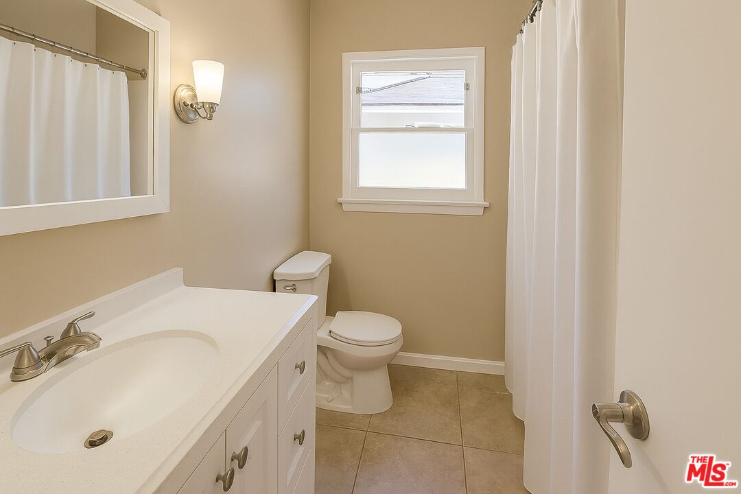 7465 North Forbes Ave Lake Lake Balboa, CA 91406 - Photo 7 of 13 a bathroom with a sink toilet and vanity