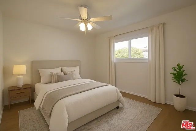 a bedroom with a bed and a potted plant