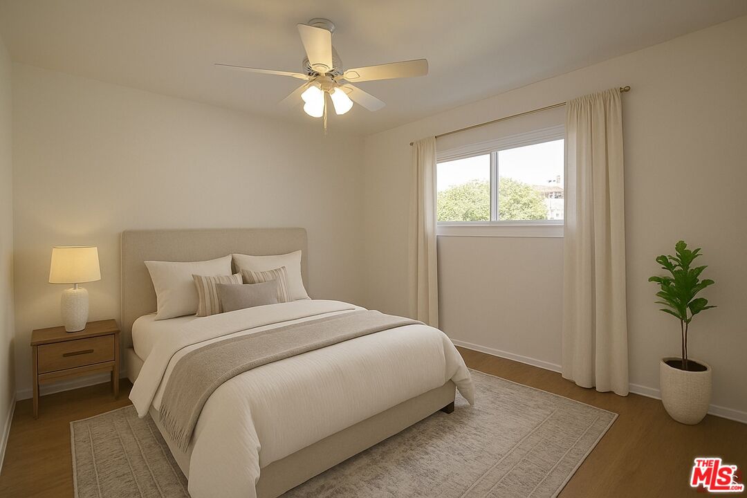 7465 North Forbes Ave Lake Lake Balboa, CA 91406 - Photo 8 of 13 a bedroom with a bed and a potted plant