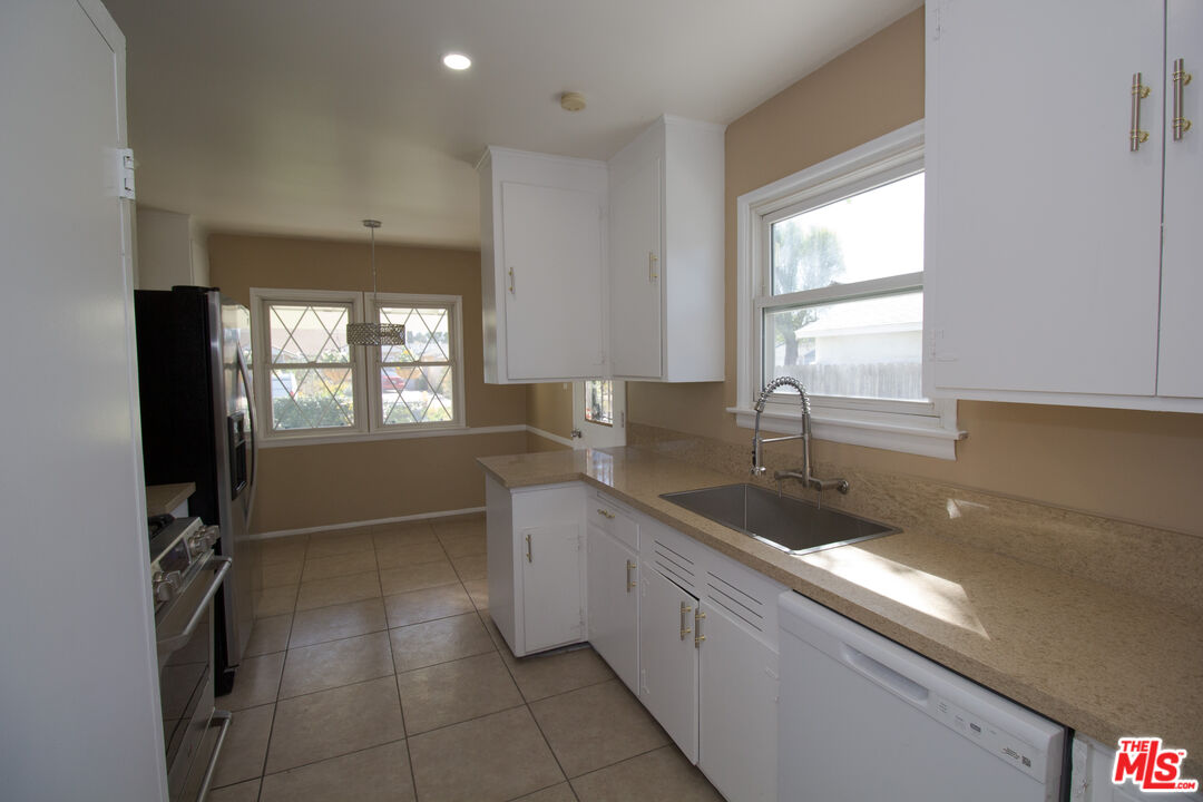 7465 North Forbes Ave Lake Lake Balboa, CA 91406 - Photo 9 of 13 a kitchen with a sink and a large window