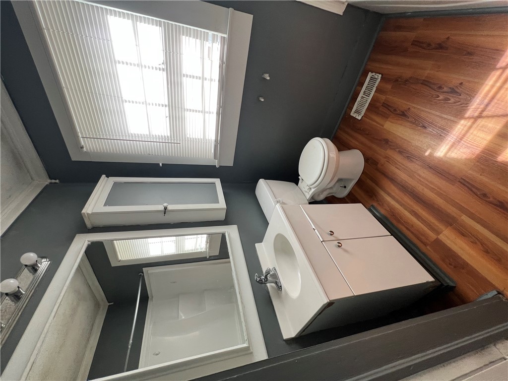 309 Jaynes Street Walhalla, SC 29691 - Photo 10 of 12 A well-lit lavatory features a compact shower stall and a practical vanity setup.