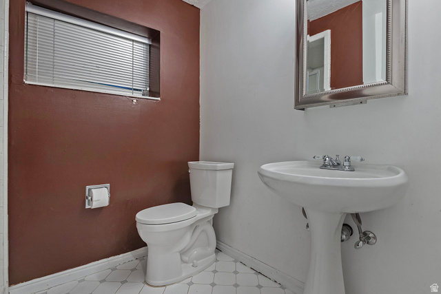 3310 Creek Road Salt Lake City, UT 84121 - Photo 31 of 49 Bathroom featuring a white pedestal sink with chrome fixtures, a white toilet, and a window with blinds