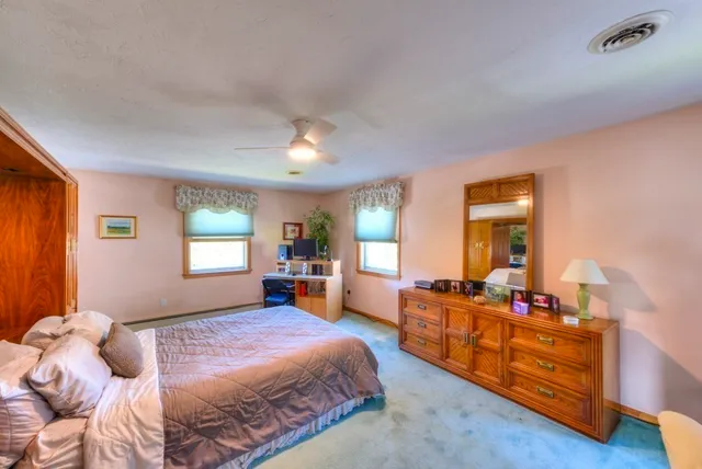 a bedroom with a bed and wooden furniture