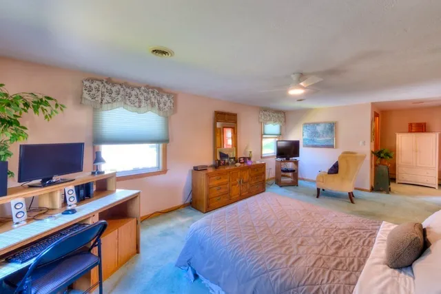 a bedroom with furniture and a wooden floor