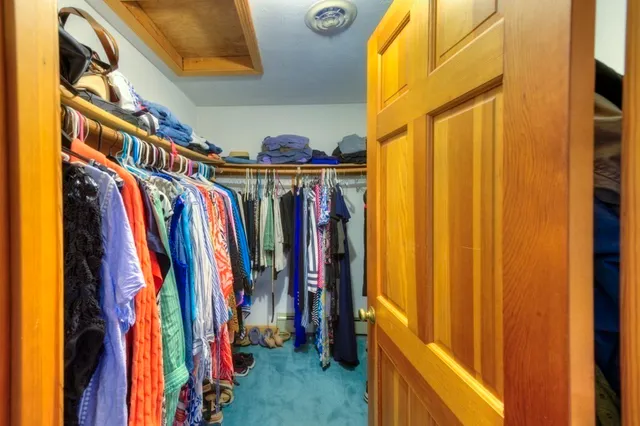 a view of walk in closet with clothes