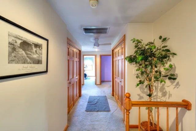 a view of hallway with wooden floor
