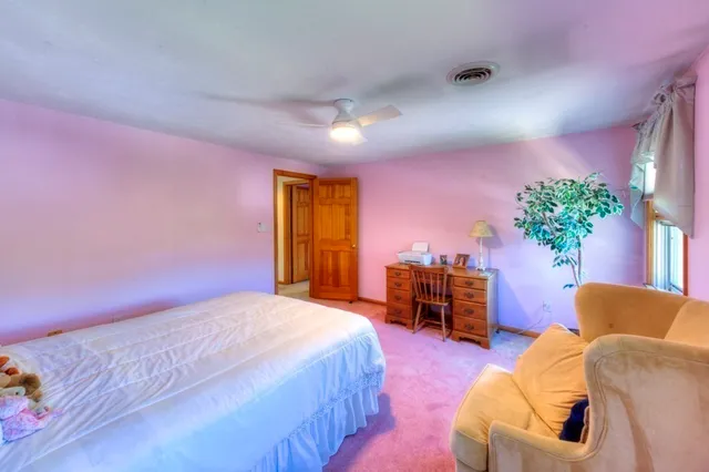 a bedroom with a bed and potted plant