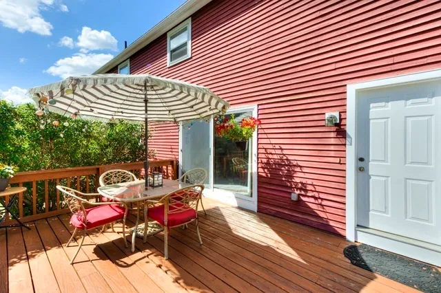 a view of a patio with a table and chairs and wooden floor