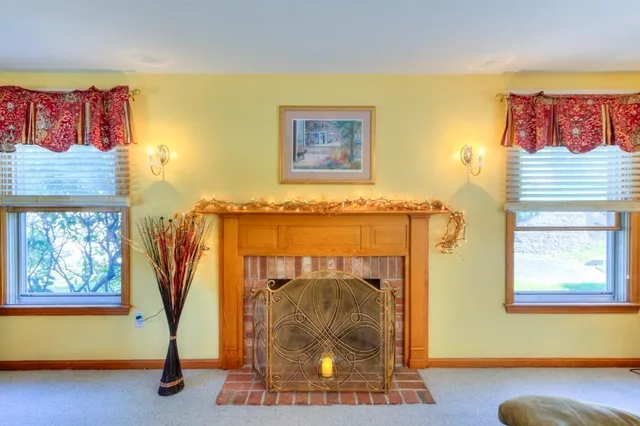 a living room with a fireplace and a rug
