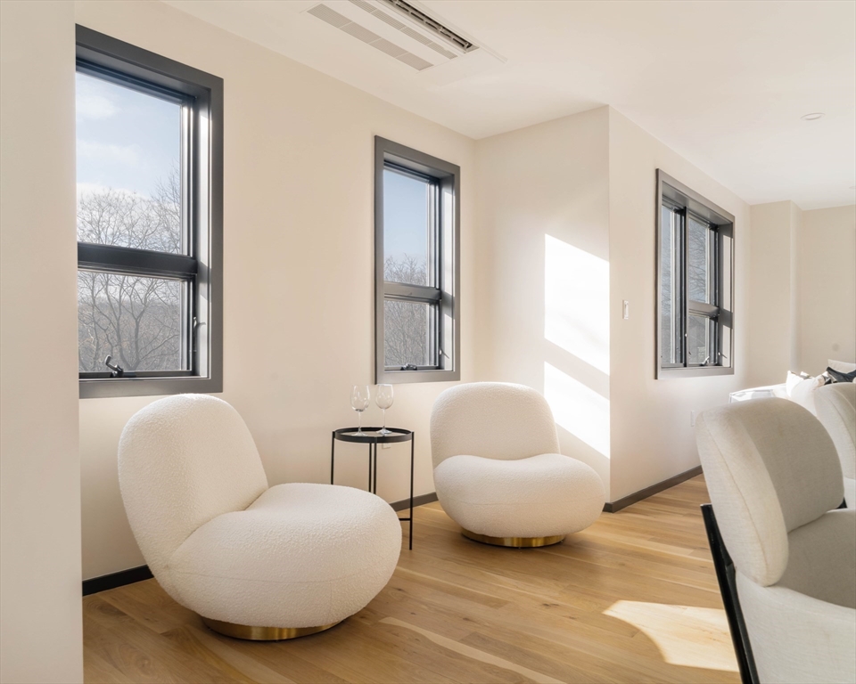 29-31 Highland Road, Unit 29 Brookline, MA 02445 - Photo 16 of 39 a living room with furniture and a window