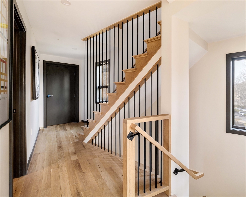 29-31 Highland Road, Unit 29 Brookline, MA 02445 - Photo 21 of 39 a view of staircase with wooden floor and a window
