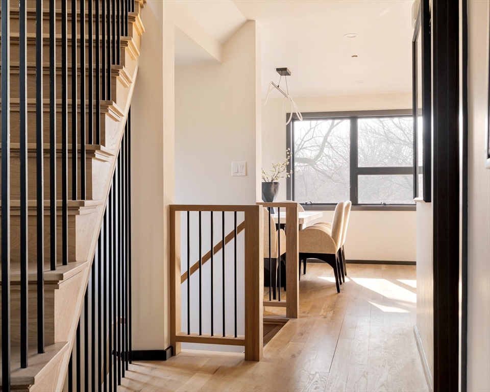 29-31 Highland Road, Unit 29 Brookline, MA 02445 - Photo 22 of 39 a view of a hallway with wooden floor and windows