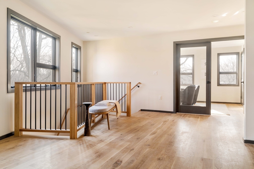 29-31 Highland Road, Unit 29 Brookline, MA 02445 - Photo 23 of 39 an empty room with wooden floor and windows