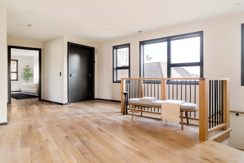 29-31 Highland Road, Unit 29 Brookline, MA 02445 - Photo 24 of 39 a view of a bedroom with furniture and windows