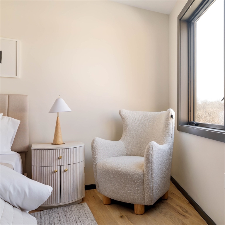 29-31 Highland Road, Unit 29 Brookline, MA 02445 - Photo 29 of 39 a living room with furniture a window and a lamp