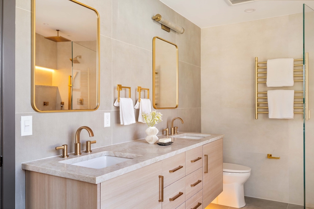 29-31 Highland Road, Unit 29 Brookline, MA 02445 - Photo 31 of 39 a bathroom with a double vanity sink and a mirror