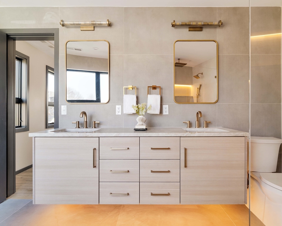 29-31 Highland Road, Unit 29 Brookline, MA 02445 - Photo 32 of 39 a bathroom with a double vanity sink mirror and