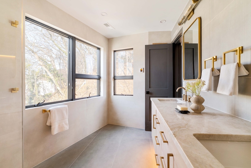 29-31 Highland Road, Unit 29 Brookline, MA 02445 - Photo 33 of 39 a kitchen with stainless steel appliances granite countertop a sink and a large window