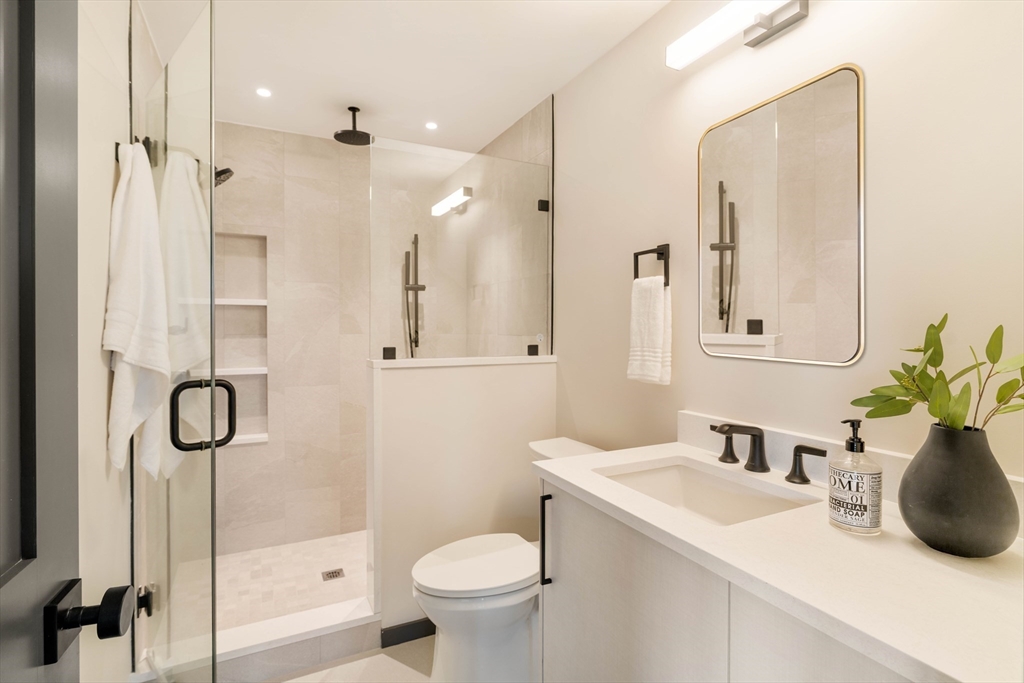 29-31 Highland Road, Unit 29 Brookline, MA 02445 - Photo 37 of 39 a bathroom with a sink toilet and shower