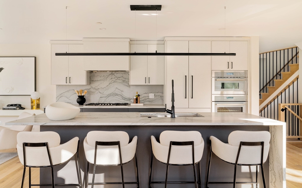 29-31 Highland Road, Unit 29 Brookline, MA 02445 - Photo 7 of 39 a kitchen with stainless steel appliances granite countertop a table chairs sink and cabinets