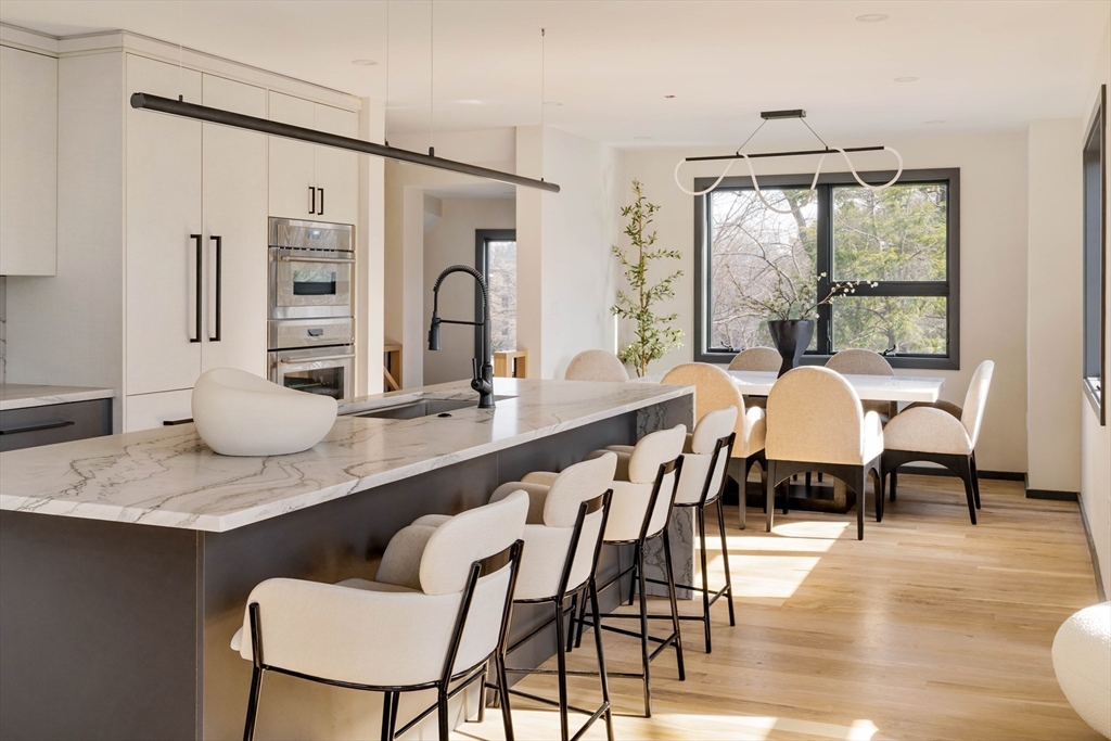 29-31 Highland Road, Unit 29 Brookline, MA 02445 - Photo 8 of 39 a dining room with furniture and wooden floor