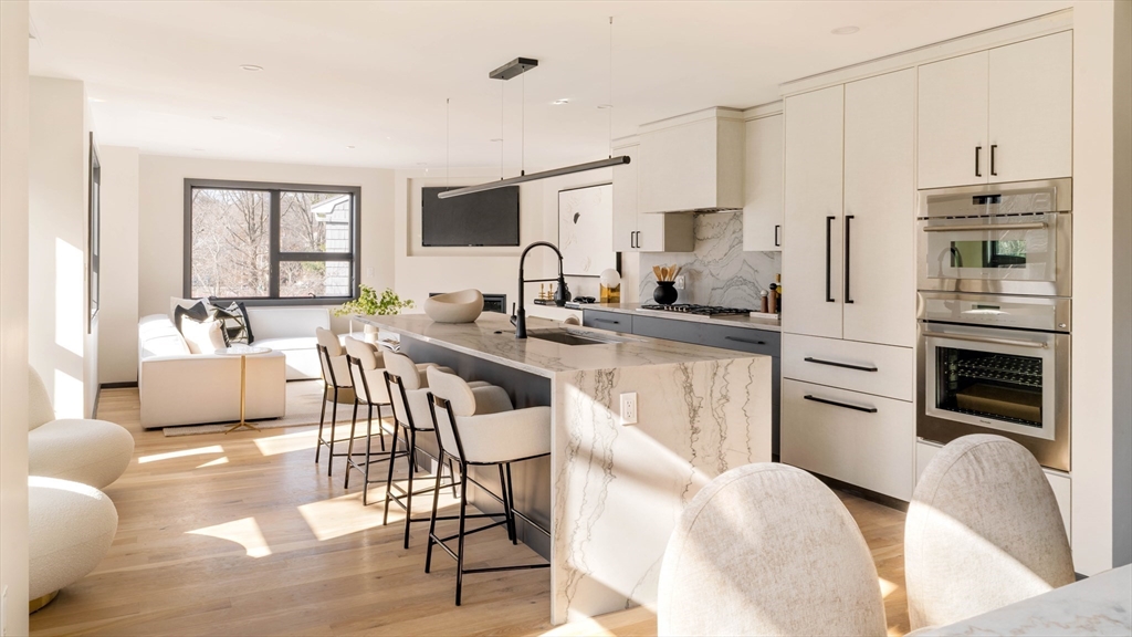 29-31 Highland Road, Unit 29 Brookline, MA 02445 - Photo 10 of 39 a kitchen with stainless steel appliances granite countertop a refrigerator and a stove top oven