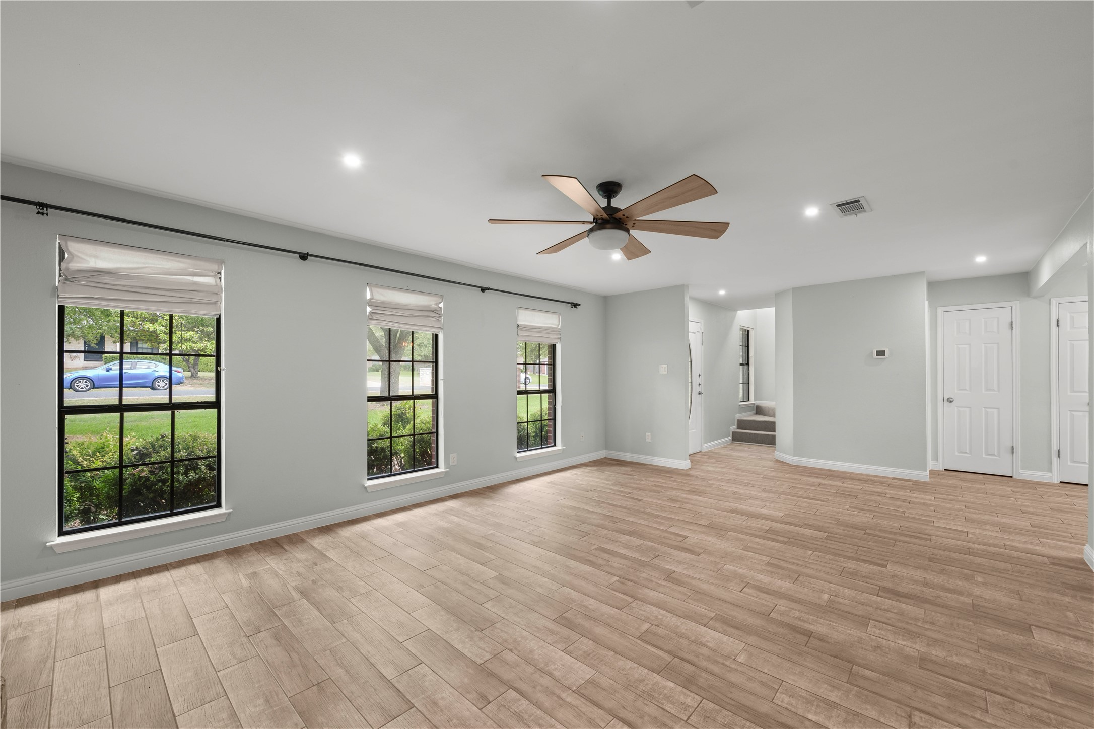 1329 Quail Ravine Round Rock, TX 78664 - Photo 35 of 39 Gleaming wood-look tile floors and multiple windows define this versatile living space.