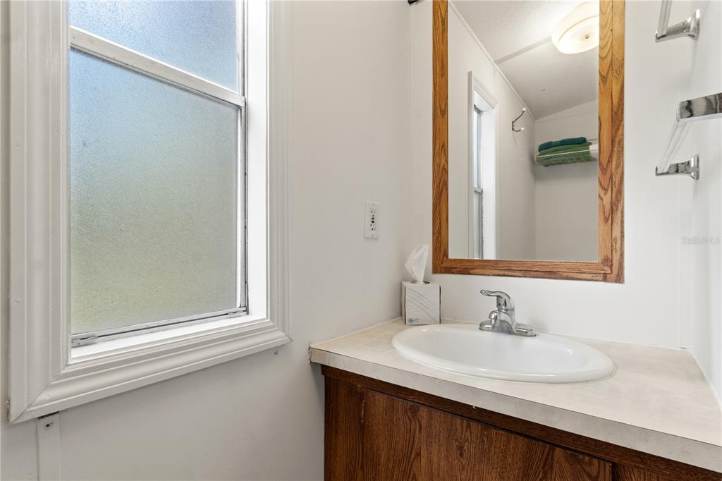 3650 176 Place Inglis, FL 34449 - Photo 31 of 49 a bathroom with a sink and a mirror