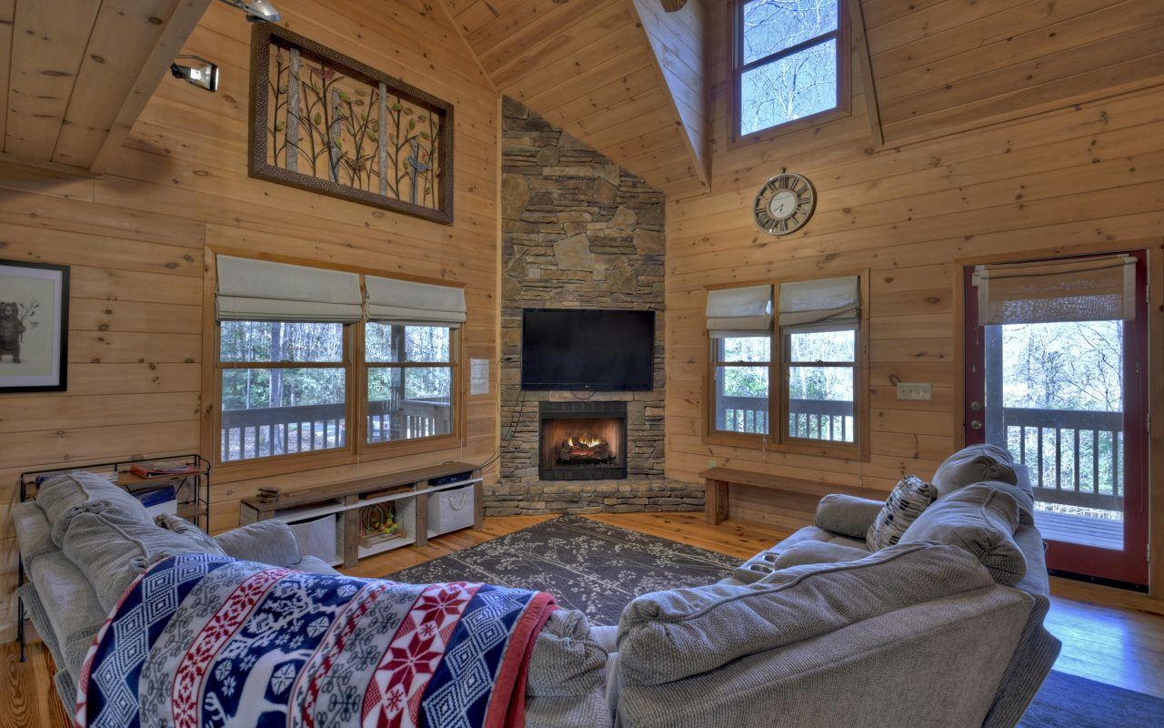 264 Sawmill Circle Blue Ridge, GA 30513 - Photo 13 of 39 a living room with furniture a flat screen tv and a fireplace