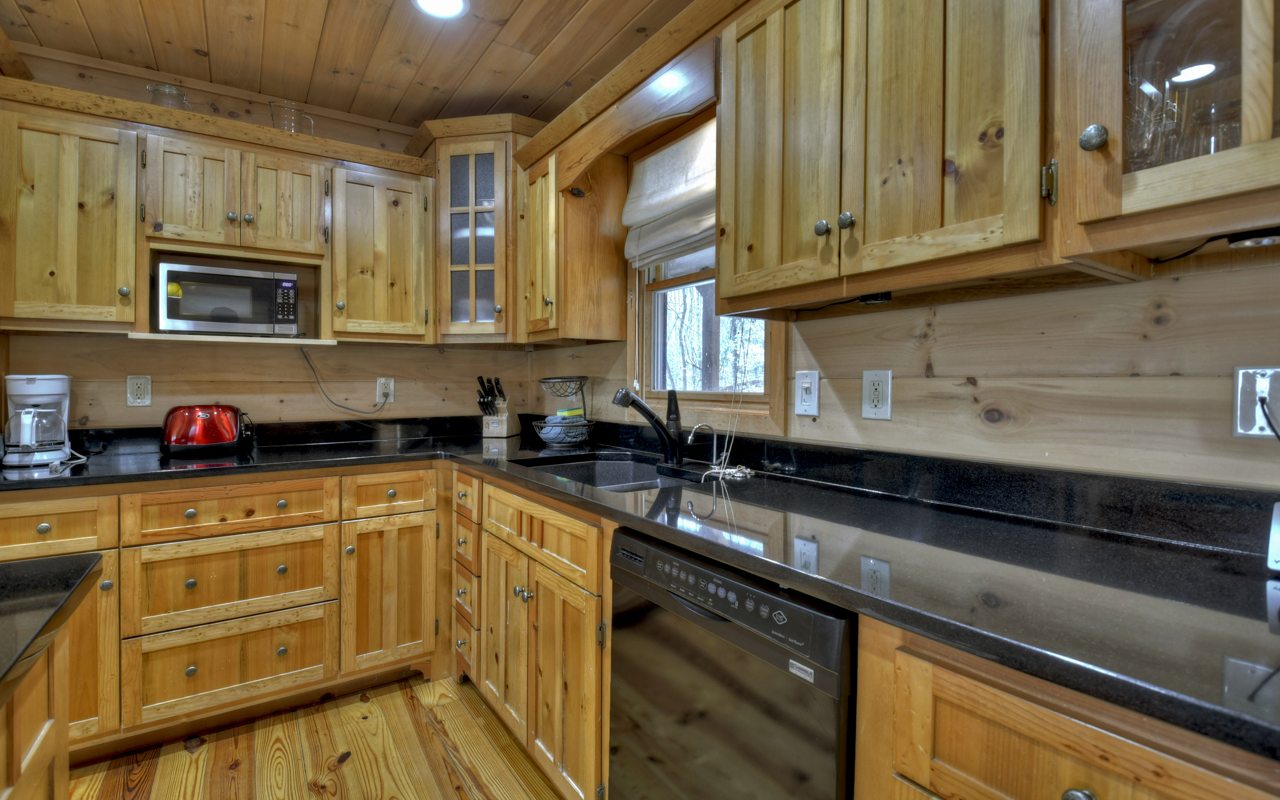 264 Sawmill Circle Blue Ridge, GA 30513 - Photo 18 of 39 a kitchen with stainless steel appliances granite countertop a sink a stove microwave and cabinets