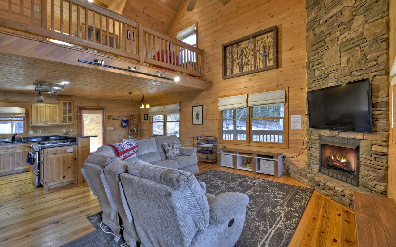 264 Sawmill Circle Blue Ridge, GA 30513 - Photo 2 of 39 a living room with fireplace furniture and a flat screen tv