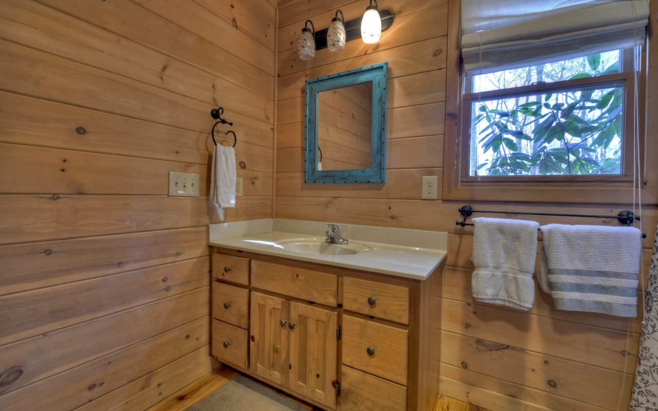 264 Sawmill Circle Blue Ridge, GA 30513 - Photo 23 of 39 a bathroom with a sink and a mirror