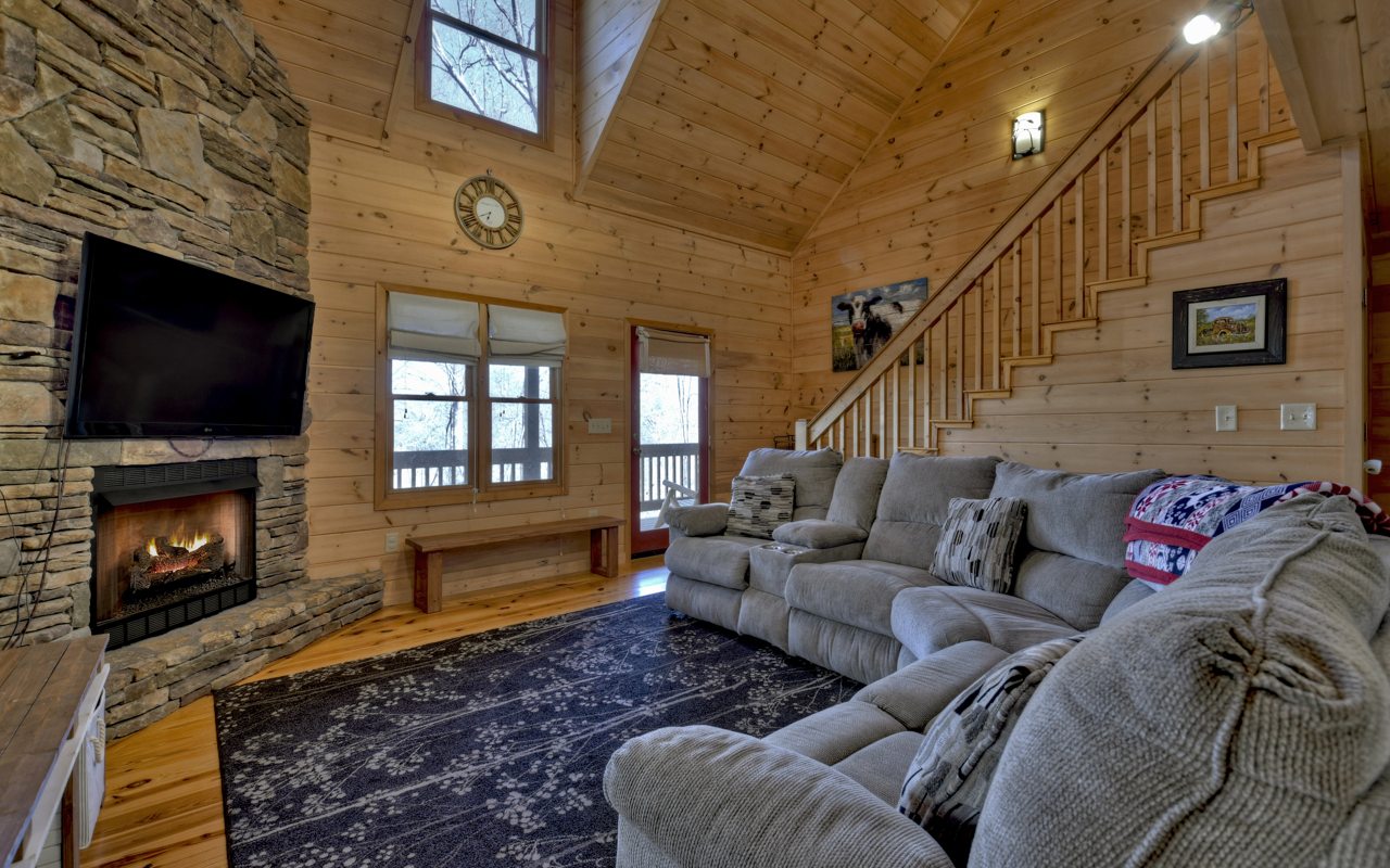 264 Sawmill Circle Blue Ridge, GA 30513 - Photo 3 of 39 a living room with furniture a fireplace and a flat screen tv