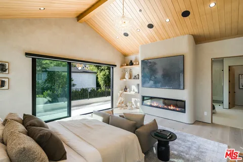 a bedroom with furniture and a flat screen tv