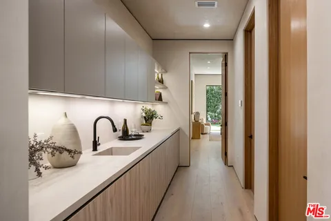 a kitchen with a refrigerator and sink