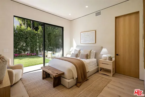 a bed room with a bed and a yard